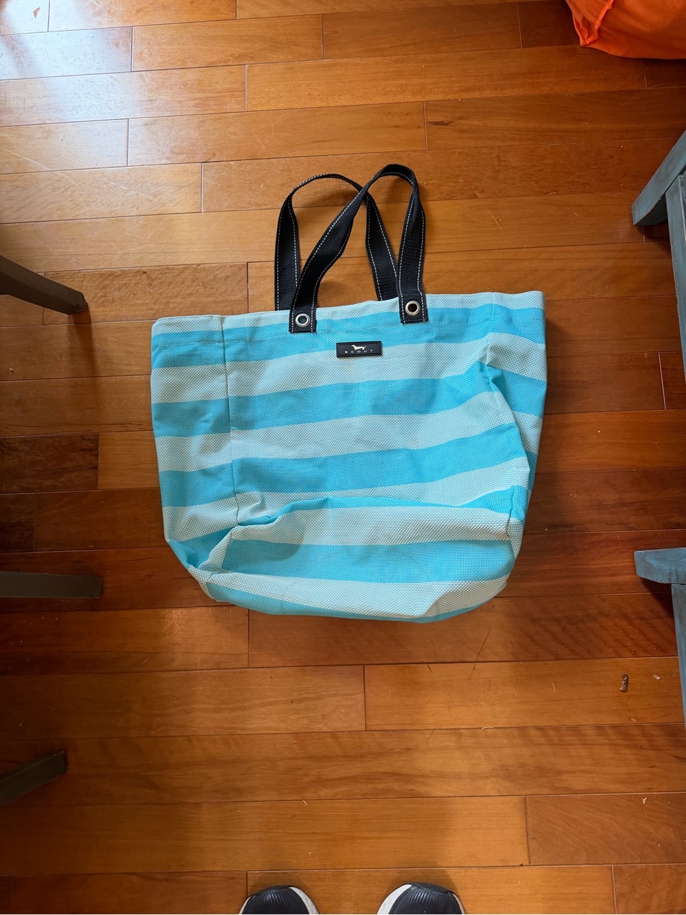 Scout beach bag blue and white striped with black handles.